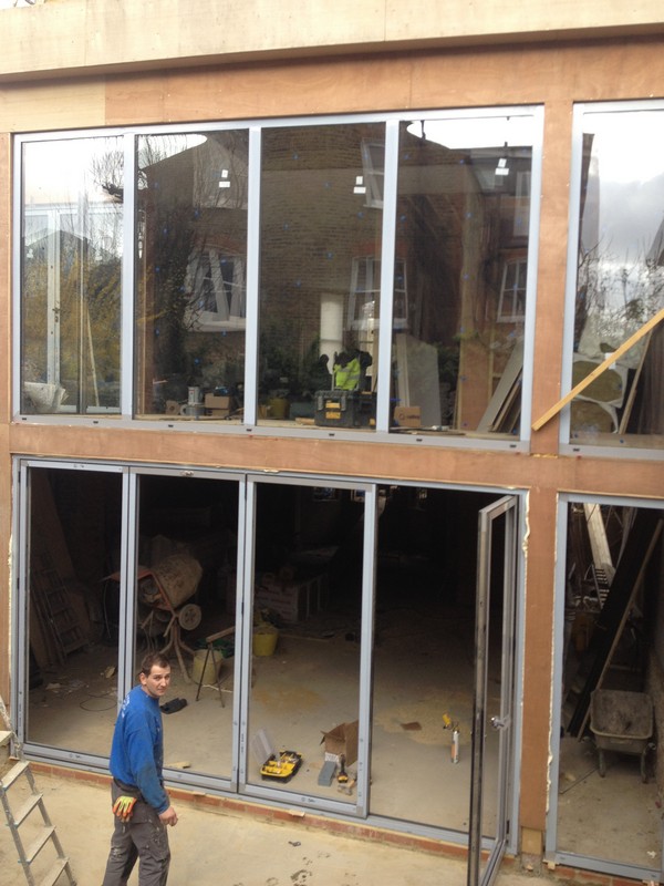 Aluminium bi-fold doors with two-storey glazing in Soho