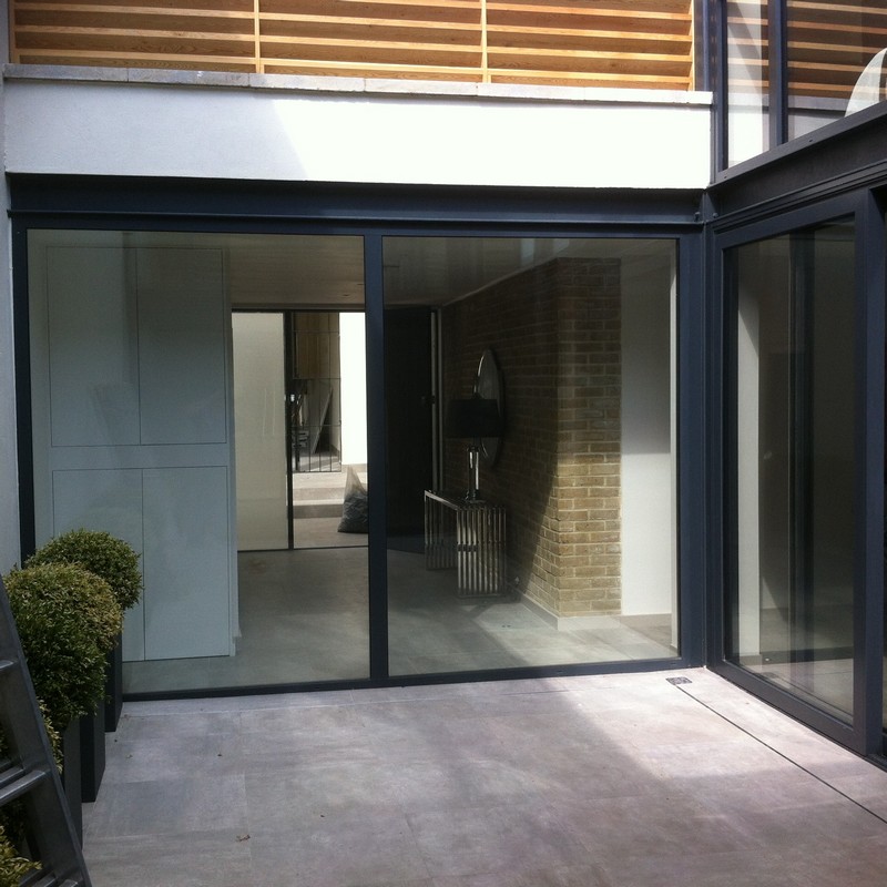 Floor-to-ceiling sliding doors opening to courtyard in Soho