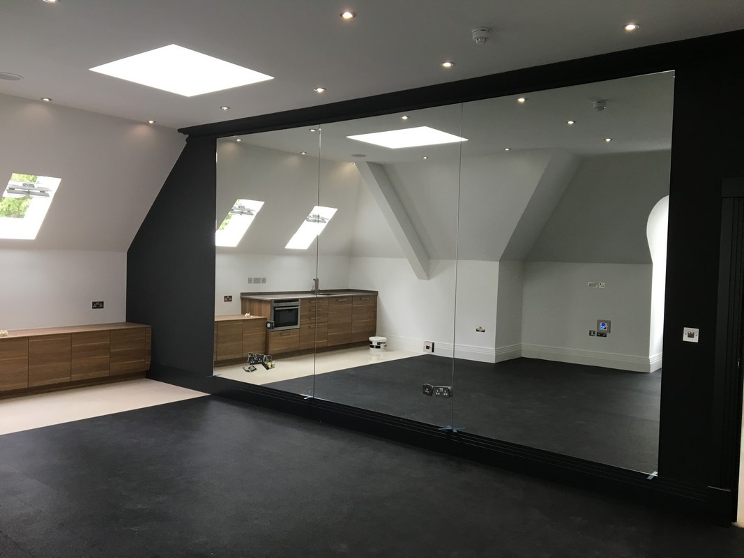 Frameless glass wall dividing loft conversion in Soho