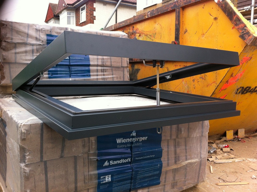 Opening flat roof skylight in anthracite grey installed in Soho