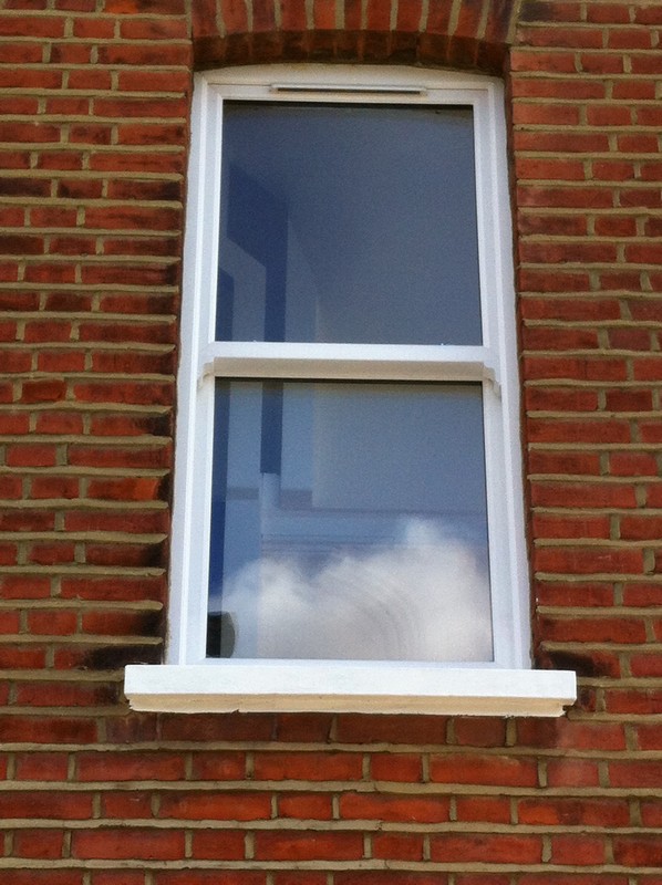 uPVC sash window on Victorian red brick house in Soho